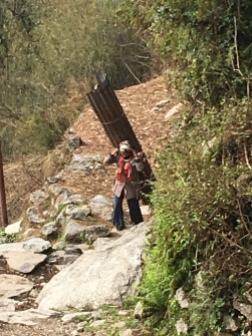 Hikers share the trail with villagers going about their d